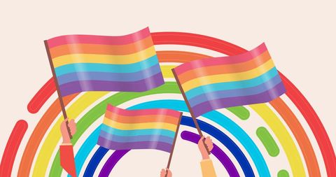 Hands holding pride flags with rainbow arc illustrating lgbtq pride