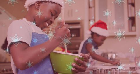 Children baking christmas cookies with santa hats in festive kitchen