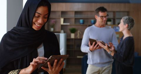 Diverse Business Team Engaged with Technology in Modern Office