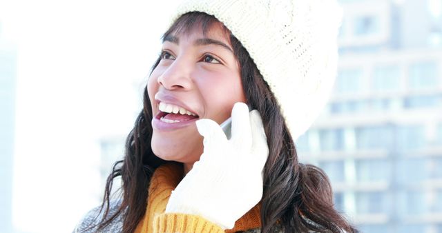 Young Woman Smiling and Talking on Phone Outdoors in Winter - Download Free Stock Images Pikwizard.com