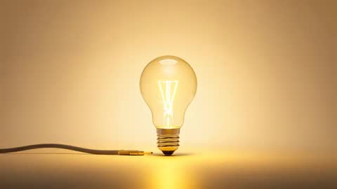 Incandescent Bulb Casting Warm Glow in Minimalist Studio