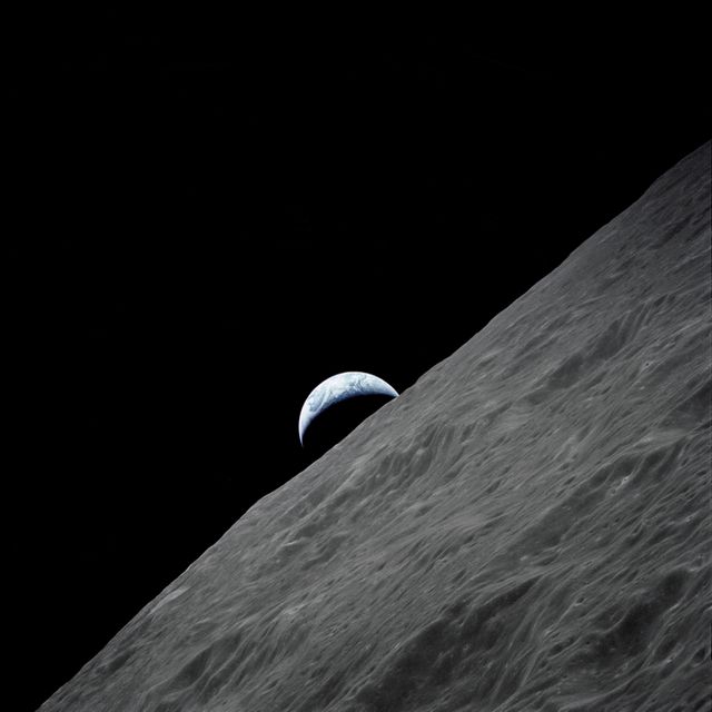 Earth is rising behind the rugged grey surface of the moon in the vast darkness of space. This image can be used for educational purposes in science classes highlighting planetary science and astronomy. It is also suitable for illustrating articles on space exploration, NASA missions, or for inspiring graphics on websites discussing celestial bodies or the universe.