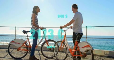 Couple Engaging with Augmented Reality Biking by the Beach