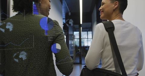 Office professionals collaborating in modern corridor with digital overlay