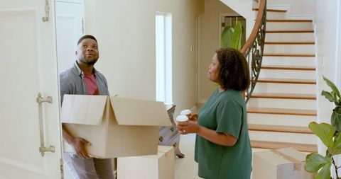 Happy Couple Drinking Coffee While Unpacking New Home