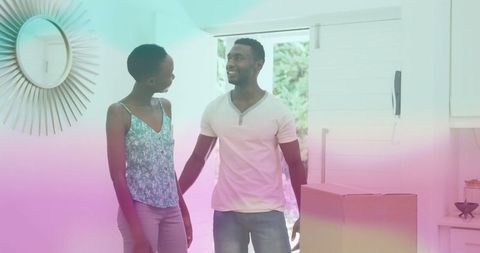 Smiling Couple Standing Near Open Front Door in Modern Home Interior