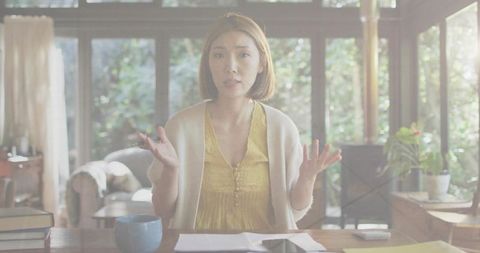 Confused Woman Sitting at Home Desk with Papers