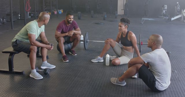 Group of Friends Taking Workout Break at Gym, Relaxing on Floor - Download Free Stock Images Pikwizard.com