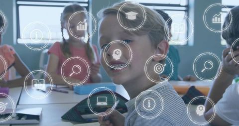 Smiling blonde boy facing camera in classroom surrounded by digital education icons for e-learning