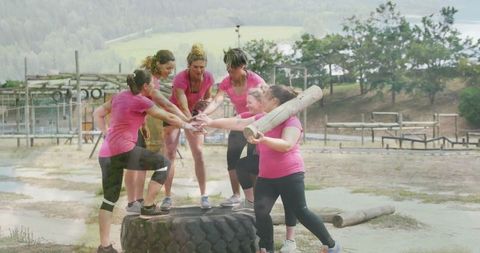 Women Exercising Teamwork on Obstacle Course Outdoors