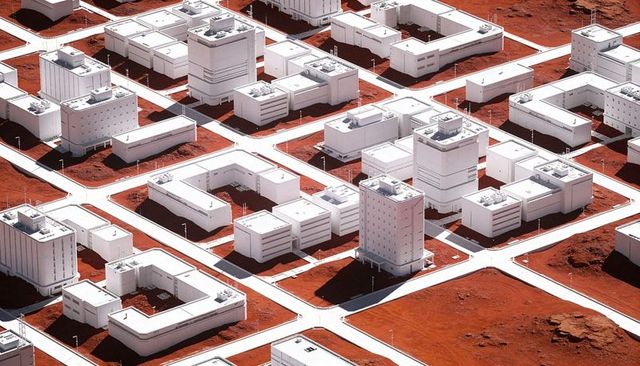 White Modular Colony Sprawling Across Red Desert Grid Landscape