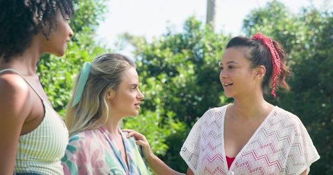 Diverse Female Friends Enjoying Sunlit Garden Conversation