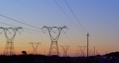 Electricity Pylons at Dusk with Vibrant Sunset Sky