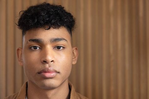 African american teen male closeup headshot looking at camera neutral expression