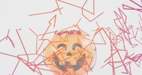 Glossy jack-o'-lantern candy pail with red gummies and geometric wireframe overlay