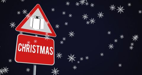 Christmas sign with gift box amid falling snowflakes