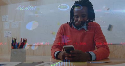 Professional Businessman Analyzing Data Using Smartphone in Office Environment