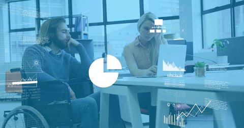 Collaborating team with wheelchair user analyzing business data overlays in modern office