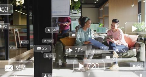 Diverse Coworkers Collaborating with Tech in Modern Office