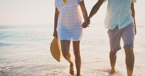 Romantic Beach Walk at Sunset with Happy Couple