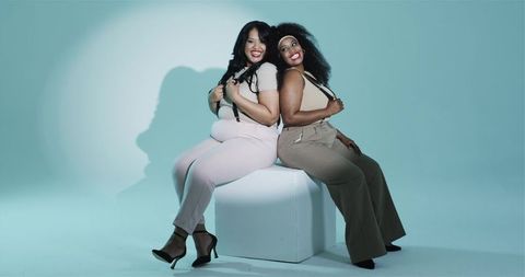 Confident women empowerment in neutral fashion posing together