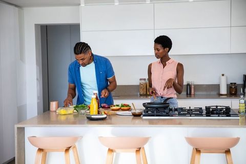 Couple Preparing Meal Together in Contemporary Kitchen Setting