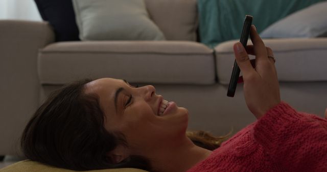 Woman Relaxing at Home Smiling While Texting on Smartphone - Download Free Stock Images Pikwizard.com