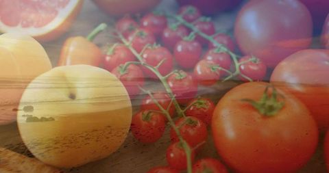 Double exposure fruit still life blending cherry tomatoes and apricot with coastal sunset