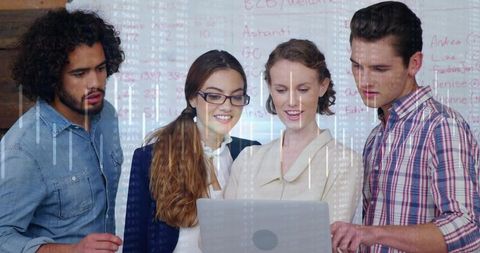 Team collaborating over laptop with data stream overlay and whiteboard brainstorming