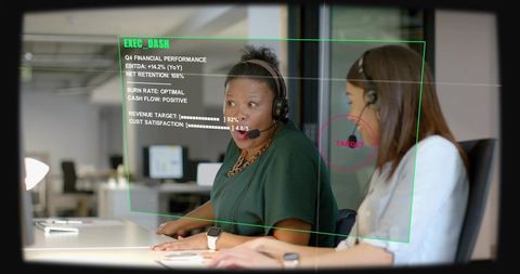 Two customer service agents reacting to ar dashboard overlay in modern office
