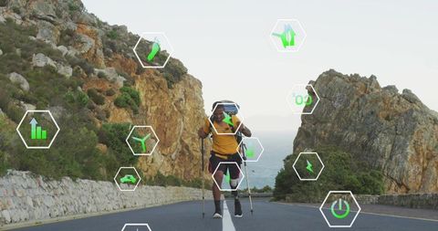 Solo hiker walking with trekking poles on coastal mountain road with eco technology icons