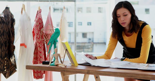 Fashion Designer Reviewing Sketches in Studio - Download Free Stock Images Pikwizard.com