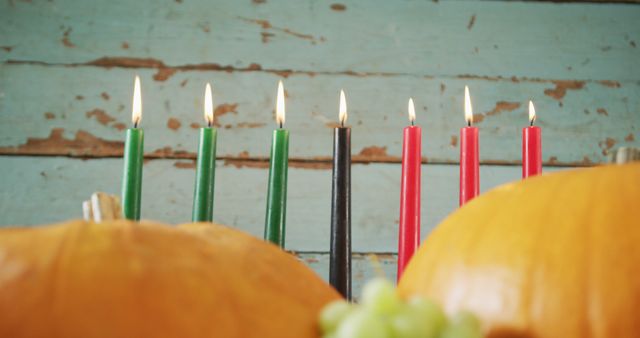 Composition of seven lit candles and halloween pumpkins and grapes - Download Free Stock Photos Pikwizard.com