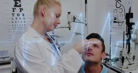 Clinician examining patient with penlight amid diagnostic equipment and ecg overlay