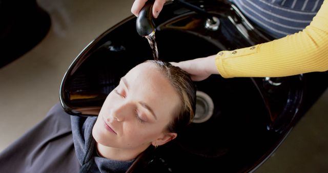 Woman Relaxing While Hairdresser Washing Hair in Salon - Download Free Stock Images Pikwizard.com