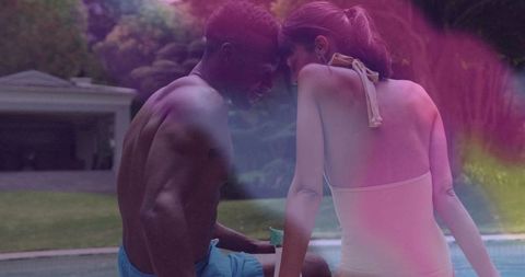 Romantic Couple Relaxing at Poolside in Luxurious Backyard