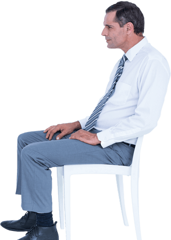 Businessman in formal attire sitting on transparent chair
