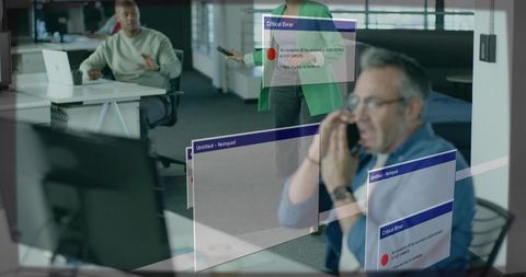 Calling on phone while critical error dialogs reflecting on office glass, colleagues reacting