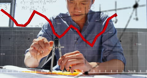 Businessman Analyzing Financial Graphs in Office