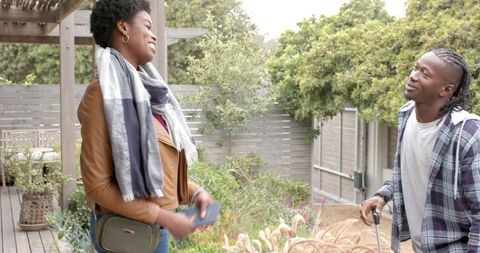 African american friends sharing pleasant moment in garden