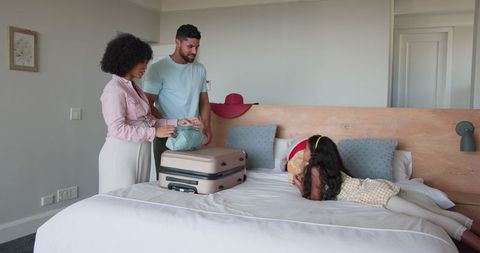 Family Preparing for Vacation with Suitcase Packing