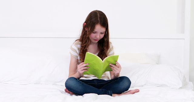 Cute girl reading a book at home