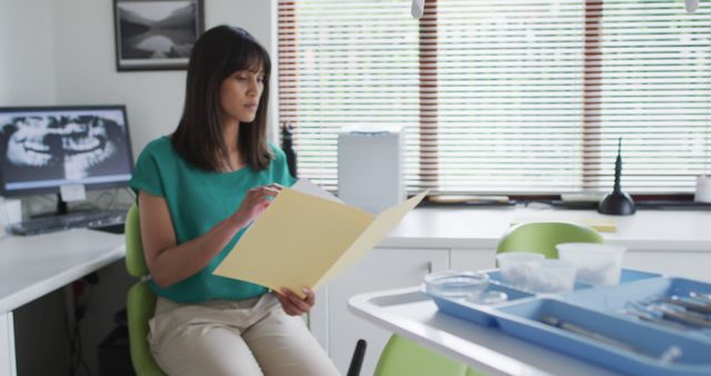 Female Dentist Reviewing Patient Records in Clinic - Download Free Stock Images Pikwizard.com