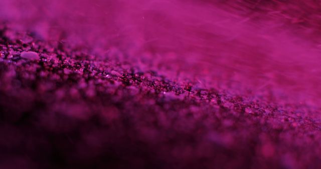 A close-up of purple glitter texture, with copy space. Captures the sparkling detail that can add a touch of glamour to design projects.
