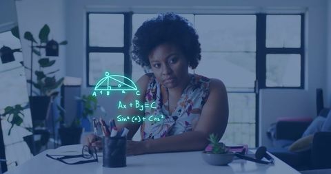 Focused african american woman analyzing mathematical equations