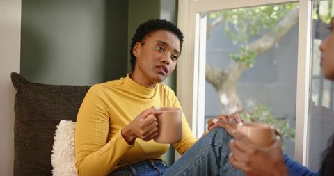 Thoughtful Woman Enjoying Afternoon Coffee Chat at Home