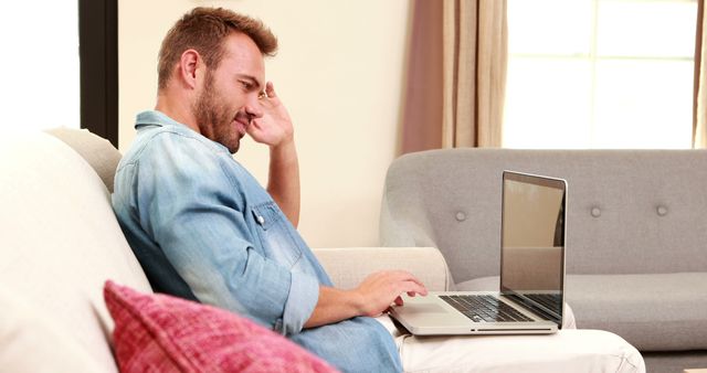 Young Man Working on Laptop at Home Relaxed and Casual - Download Free Stock Images Pikwizard.com