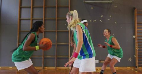 School girls basketball defending on indoor wooden court showing teamwork and movement