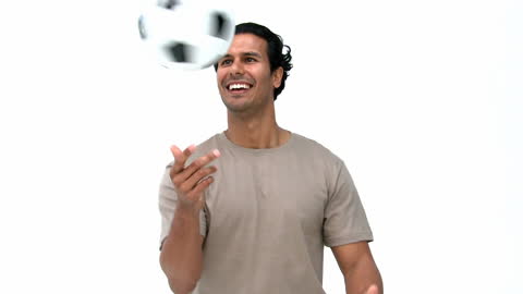 Happy Man Playing with Soccer Ball on White Background