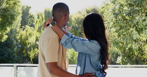 Romantic Couple Embracing Outdoors with Scenic Foliage